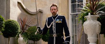 Movie still from “Gulliver's Travels” (2010), directed by Rob Letterman – A man dressed in a uniform holding a sword; Medium shot, Low angle