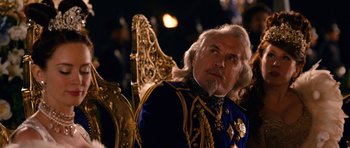 Movie still from “Gulliver's Travels” (2010), directed by Rob Letterman – An older man in a blue and gold suit; Medium shot, Over the shoulder angle