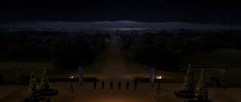 Movie still from “Gulliver's Travels” (2010), directed by Rob Letterman – A group of people standing on a walkway at night; Extreme Wide shot, High angle