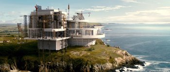 Movie still from “Gulliver's Travels” (2010), directed by Rob Letterman – A building on top of a hill near the ocean; Extreme Wide shot, High angle