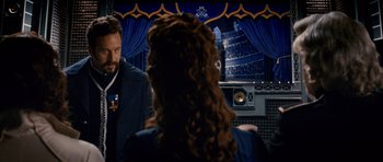 Movie still from “Gulliver's Travels” (2010), directed by Rob Letterman – A man and a woman in front of a microphone; Medium shot, Over the shoulder angle