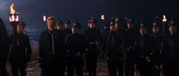 Movie still from “Gulliver's Travels” (2010), directed by Rob Letterman – A group of men in uniform standing next to each other; Wide shot, Over the shoulder angle