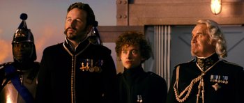 Movie still from “Gulliver's Travels” (2010), directed by Rob Letterman – A group of people standing next to each other; Close Up shot, Over the shoulder angle