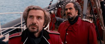 Movie still from “Gulliver's Travels” (2010), directed by Rob Letterman – Two men dressed in red are on a boat; Close Up shot, Low angle