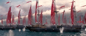 Movie still from “Gulliver's Travels” (2010), directed by Rob Letterman – Many red sails on a boat in the ocean; Extreme Wide shot, High angle