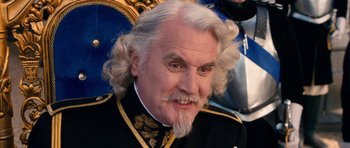 Movie still from “Gulliver's Travels” (2010), directed by Rob Letterman – An older man with white hair wearing a black suit; Close Up shot, High angle