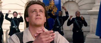 Movie still from “Gulliver's Travels” (2010), directed by Rob Letterman – A man claps his hands in front of two other men; Close Up shot, Low angle