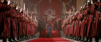 Movie still from “Gulliver's Travels” (2010), directed by Rob Letterman – A man kneeling down on a red carpet in front of a group of people; Extreme Wide shot, High angle