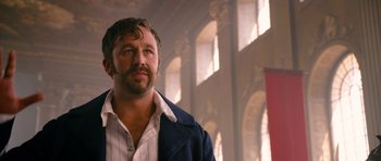 Movie still from “Gulliver's Travels” (2010), directed by Rob Letterman – A man with a goatee standing in front of a window; Close Up shot, Low angle