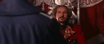 Movie still from “Gulliver's Travels” (2010), directed by Rob Letterman – A man with a beard is looking into the camera; Close Up shot, Over the shoulder angle