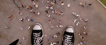 Movie still from “Gulliver's Travels” (2010), directed by Rob Letterman – A view of a person's feet from the ground looking down at a group of people; Extreme Wide shot, Overhead angle