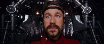 Movie still from “Gulliver's Travels” (2010), directed by Rob Letterman – A man with a beard wearing a red uniform; Close Up shot, Overhead angle