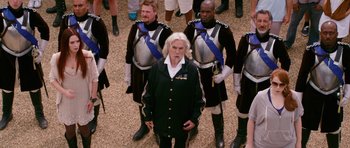 Movie still from “Gulliver's Travels” (2010), directed by Rob Letterman – A group of men standing next to each other in uniforms; Wide shot, Over the shoulder angle