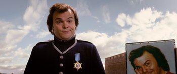 Movie still from “Gulliver's Travels” (2010), directed by Rob Letterman – A man in a uniform with a medal around his neck; Close Up shot, Over the shoulder angle