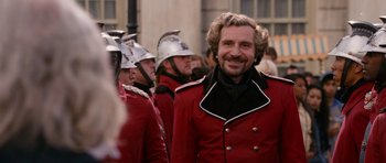 Movie still from “Gulliver's Travels” (2010), directed by Rob Letterman – A group of men in red and black uniforms; Medium shot, Over the shoulder angle