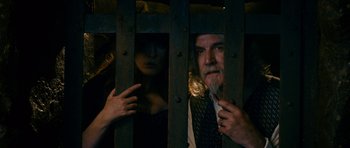 Movie still from “Gulliver's Travels” (2010), directed by Rob Letterman – A man and a woman looking through a fence; Medium shot, Low angle