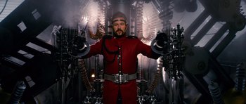 Movie still from “Gulliver's Travels” (2010), directed by Rob Letterman – A man dressed in a red suit and a red hat; Medium shot, Low angle