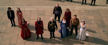 Movie still from “Gulliver's Travels” (2010), directed by Rob Letterman – A group of people standing on the sidewalk; Wide shot, Overhead angle