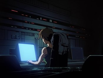 Movie still from “Gundam Wing: The Movie - Endless Waltz” (1998), directed by Yasunao Aoki – A man sitting in front of a computer screen; Wide shot, Low angle