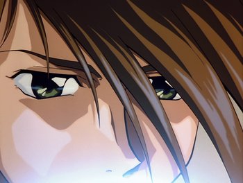 Movie still from “Gundam Wing: The Movie - Endless Waltz” (1998), directed by Yasunao Aoki – View of a person's eyes with long brown hair; Extreme Close Up shot, Low angle