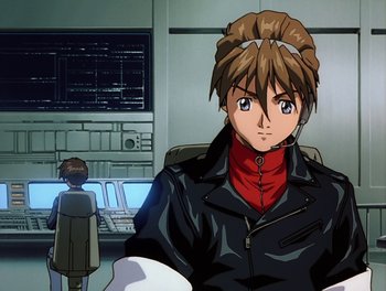 Movie still from “Gundam Wing: The Movie - Endless Waltz” (1998), directed by Yasunao Aoki – An animated picture of a man in a leather jacket; Medium shot, Low angle