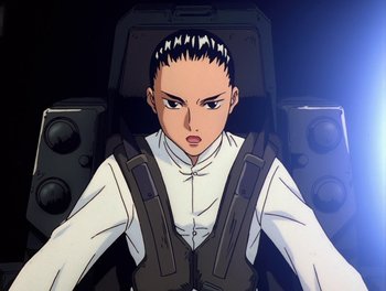 Movie still from “Gundam Wing: The Movie - Endless Waltz” (1998), directed by Yasunao Aoki – An animated woman in white shirt and black jacket; Medium shot, Low angle