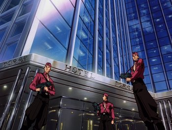 Movie still from “Gundam Wing: The Movie - Endless Waltz” (1998), directed by Yasunao Aoki – A group of men standing in front of a building; Wide shot, Low angle