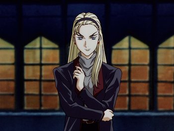 Movie still from “Gundam Wing: The Movie - Endless Waltz” (1998), directed by Yasunao Aoki – A woman with long blonde hair standing in front of a building; Medium shot, High angle