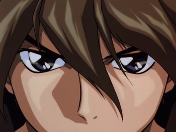 Movie still from “Gundam Wing: The Movie - Endless Waltz” (1998), directed by Yasunao Aoki – A person's face with blue eyes and brown hair; Extreme Close Up shot, Low angle