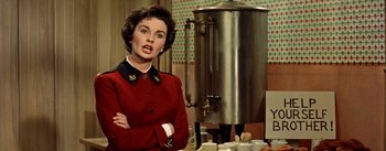 Movie still from “Guys and Dolls” (1955), directed by Joseph L. Mankiewicz – A woman standing in front of a coffee pot; Close Up shot, Over the shoulder angle