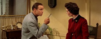 Movie still from “Guys and Dolls” (1955), directed by Joseph L. Mankiewicz – A man and a woman are talking to each other; Medium shot, Low angle