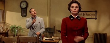 Movie still from “Guys and Dolls” (1955), directed by Joseph L. Mankiewicz – A man and a woman standing next to each other in a room; Medium shot, Over the shoulder angle