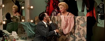 Movie still from “Guys and Dolls” (1955), directed by Joseph L. Mankiewicz – A man and a woman are dressed up in vintage clothing; Medium shot, Overhead angle