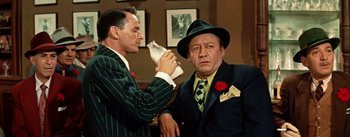 Movie still from “Guys and Dolls” (1955), directed by Joseph L. Mankiewicz – A man in a suit and a man in a hat; Medium shot, High angle