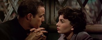 Movie still from “Guys and Dolls” (1955), directed by Joseph L. Mankiewicz – A man and a woman looking at each other; Close Up shot, Over the shoulder angle