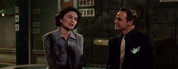 Movie still from “Guys and Dolls” (1955), directed by Joseph L. Mankiewicz – A man and a woman talking to each other; Medium shot, Over the shoulder angle