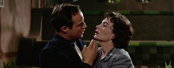 Movie still from “Guys and Dolls” (1955), directed by Joseph L. Mankiewicz – A man and a woman are touching each other's face; Close Up shot, Low angle