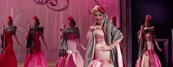 Movie still from “Guys and Dolls” (1955), directed by Joseph L. Mankiewicz – A group of women dressed up in pink gowns and hats; Medium shot, Over the shoulder angle