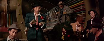 Movie still from “Guys and Dolls” (1955), directed by Joseph L. Mankiewicz – A group of men standing next to each other holding money; Medium shot, Low angle