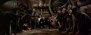Movie still from “Guys and Dolls” (1955), directed by Joseph L. Mankiewicz – A group of men in suits and green hats; Wide shot, High angle
