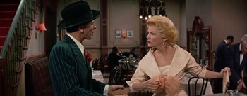 Movie still from “Guys and Dolls” (1955), directed by Joseph L. Mankiewicz – A man and a woman talking in a restaurant; Medium shot, Over the shoulder angle