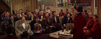 Movie still from “Guys and Dolls” (1955), directed by Joseph L. Mankiewicz – A group of men in suits and ties sitting around a table; Wide shot, High angle