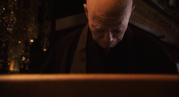 Movie still from “Hachi: A Dog's Tale” (2009), directed by Lasse Hallström – An older bald man looking at a laptop computer; Close Up shot, Low angle