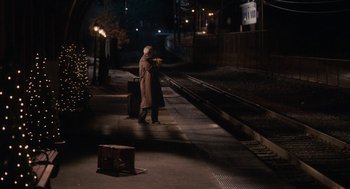 Movie still from “Hachi: A Dog's Tale” (2009), directed by Lasse Hallström – An old man walking on a train platform at night; Wide shot, High angle