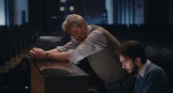 Movie still from “Hachi: A Dog's Tale” (2009), directed by Lasse Hallström – A man sitting at a piano with another man standing next to him; Medium shot, High angle