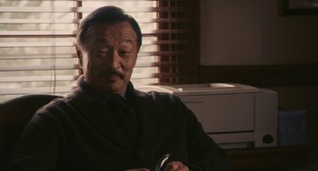 Movie still from “Hachi: A Dog's Tale” (2009), directed by Lasse Hallström – An older man sitting in front of an air conditioner; Close Up shot, Over the shoulder angle