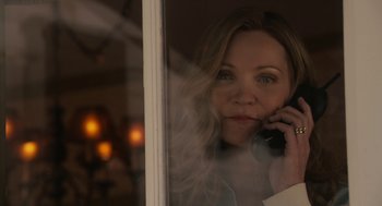 Movie still from “Hachi: A Dog's Tale” (2009), directed by Lasse Hallström – A woman talking on a cell phone through a window; Close Up shot, Over the shoulder angle