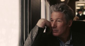 Movie still from “Hachi: A Dog's Tale” (2009), directed by Lasse Hallström – A person leaning against a window sill; Close Up shot, Over the shoulder angle