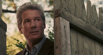 Movie still from “Hachi: A Dog's Tale” (2009), directed by Lasse Hallström – A person wearing a suit and tie; Close Up shot, Over the shoulder angle