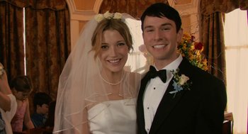 Movie still from “Hachi: A Dog's Tale” (2009), directed by Lasse Hallström – A man and woman posing for a picture in their wedding attire; Close Up shot, Low angle